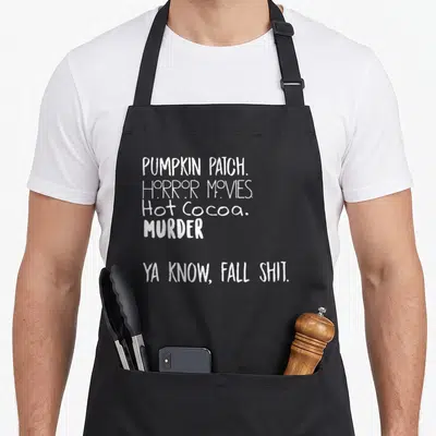 Pumpkin horror movie apron - White stacked text reading Pumpkin Patch Horror Movies Hot Cocoa Murder Fall Shit — shown on a black cotton canvas apron against a white background