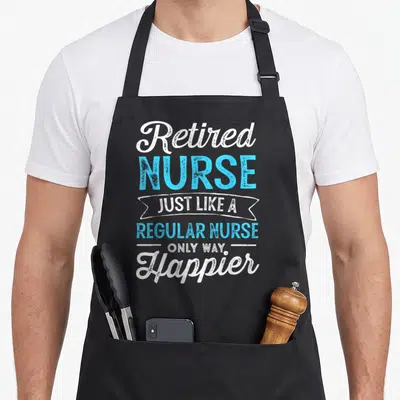 Retired nurse apron - White and blue stacked text design reading Retired Nurse Just Like A Regular Nurse Only Way — shown on a black cotton canvas apron against a white background