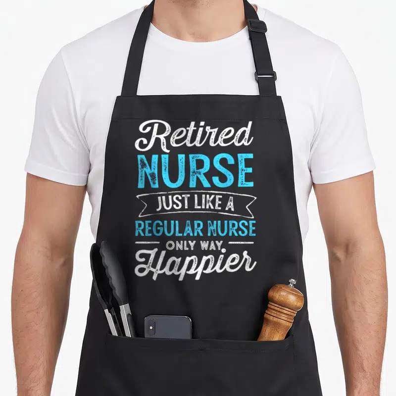 Retired nurse apron - White and blue stacked text design reading Retired Nurse Just Like A Regular Nurse Only Way — shown on a black cotton canvas apron against a white background