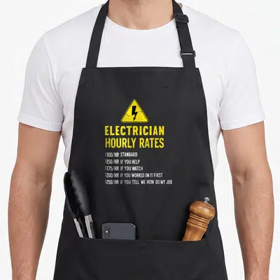 Labor electrician apron - Yellow warning sign with lightning bolt and white text listing sarcastic electrician hourly — shown on a black cotton canvas apron against a white background