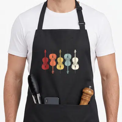 70s cello apron - Five cellos in red orange yellow light blue and off-white arranged horizontally — shown on a black cotton canvas apron against a white background
