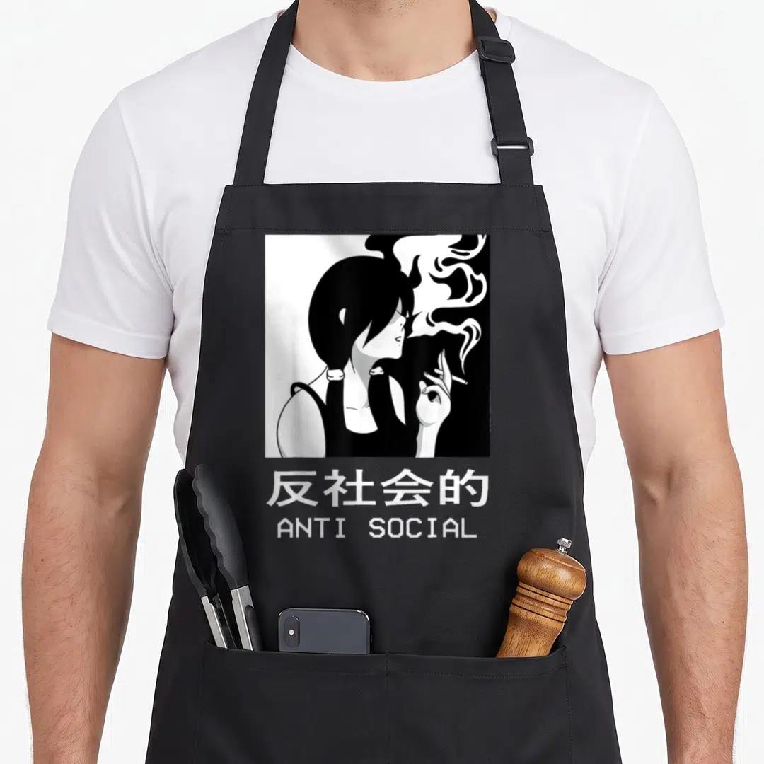 Goth anime apron - Woman smoking line art with ANTI SOCIAL text and Japanese characters — shown on a black cotton canvas apron against a white background