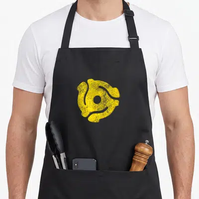 Adapter turntables and aprons - Distressed yellow 45 RPM record adapter symbol centered on grey background — shown on a black cotton canvas apron against a white background