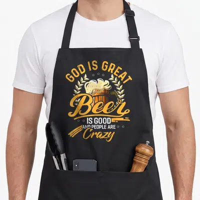 Brewery beer apron - Retro orange beer mug with wheat stalks and text God is Great Beer is Good and People are Crazy — shown on a black cotton canvas apron against a white background
