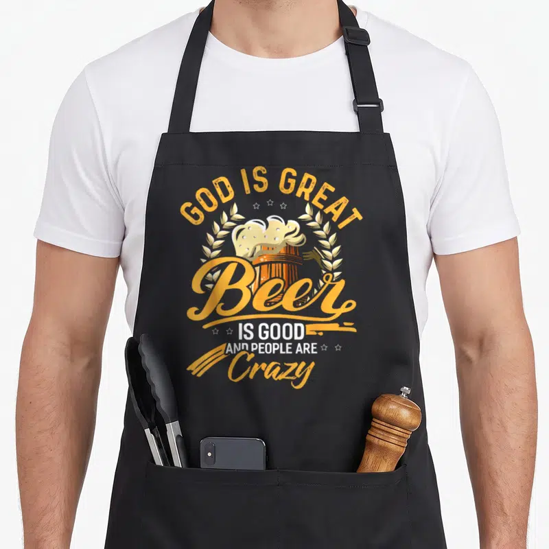 Brewery beer apron - Retro orange beer mug with wheat stalks and text God is Great Beer is Good and People are Crazy — shown on a black cotton canvas apron against a white background