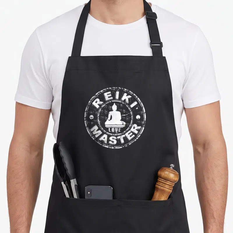 Holistic master apron - White distressed stamp with Buddha silhouette and text REIKI LOVE MASTER — shown on a black cotton canvas apron against a white background