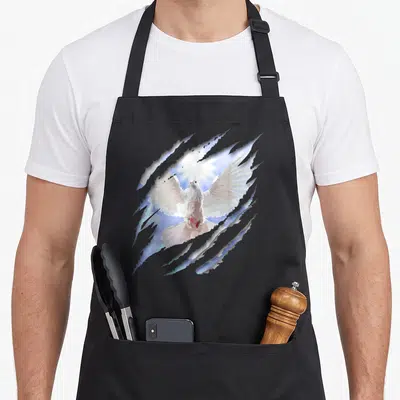 Dove christian apron - Realistic white dove flying through grey torn paper revealing blue sky and bright sun — shown on a black cotton canvas apron against a white background