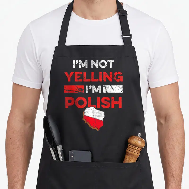 Heritage polish kitchen aprons - Stacked I'm Not Yelling I'm Polish text above a distressed white and red map of Poland — shown on a black cotton canvas apron against a white background