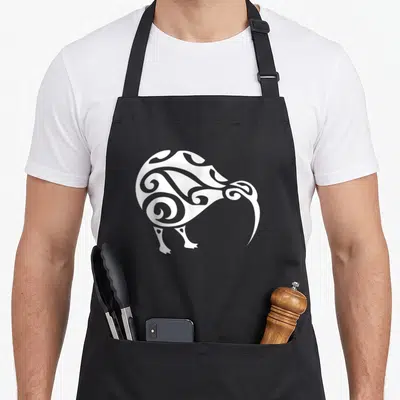 Aboriginal new zealand apron - White line-art kiwi bird silhouette with tribal swirls centered on grey background — shown on a black cotton canvas apron against a white background