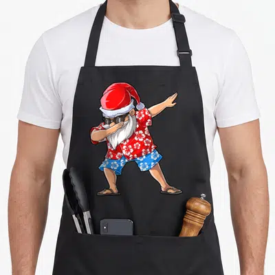 Hawaiian christmas santa apron - Cartoon Santa dabbing in red floral shirt and blue floral shorts with sunglasses — shown on a black cotton canvas apron against a white background