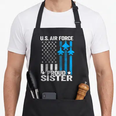 Sister us aprons - Distressed white text U.S. Air Force Proud Sister with blue jets and stars — shown on a black cotton canvas apron against a white background