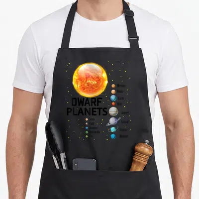 Planet solar system apron - Sun and labeled planets including Ceres Pluto Haumea Makemake Eris in yellow orange blue — shown on a black cotton canvas apron against a white background
