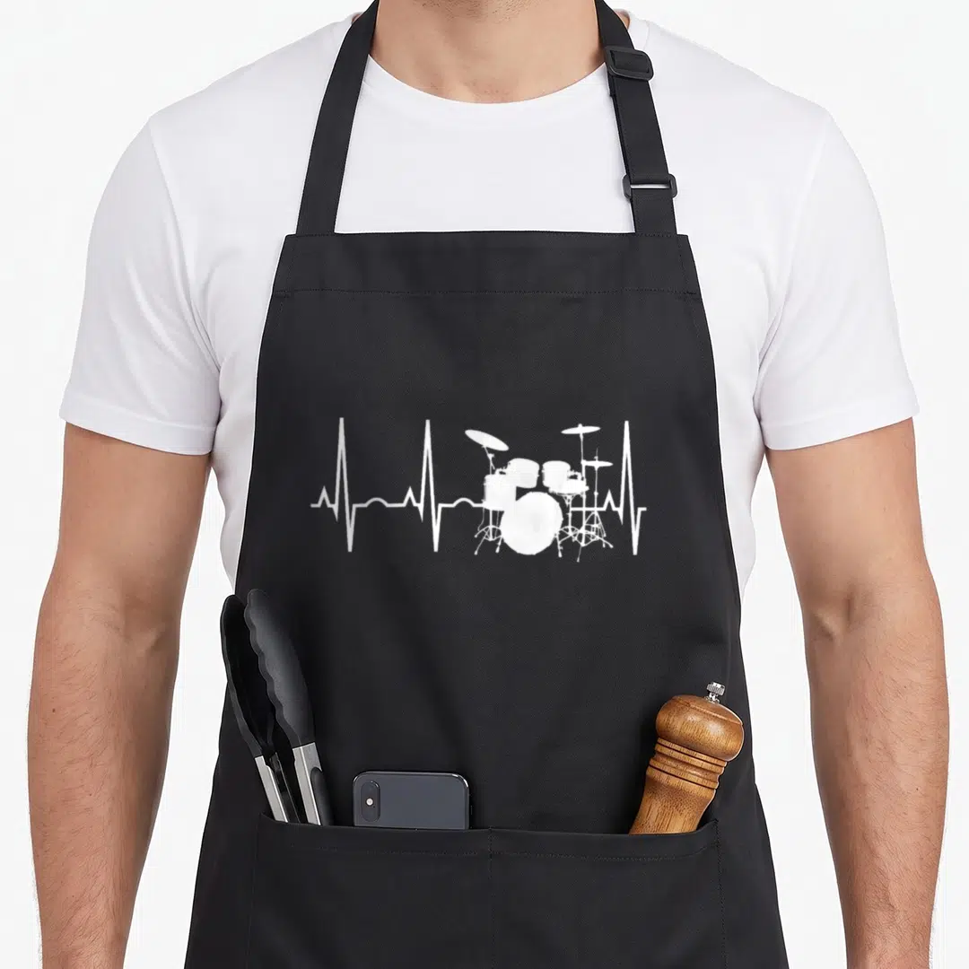 Drummer beat apron - White EKG line with drum kit silhouette centered on grey background — shown on a black cotton canvas apron against a white background