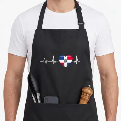 Republic heartbeat dominican apron - Heart shaped Dominican flag in blue white and red on white pulse line — shown on a black cotton canvas apron against a white background