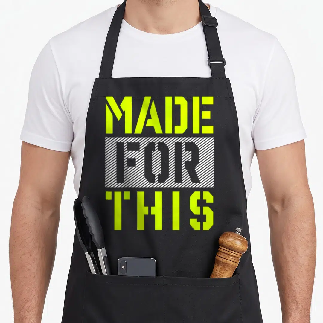Athletic lime apron - MADE FOR THIS text in lime green with FOR inside a white striped box — shown on a black cotton canvas apron against a white background
