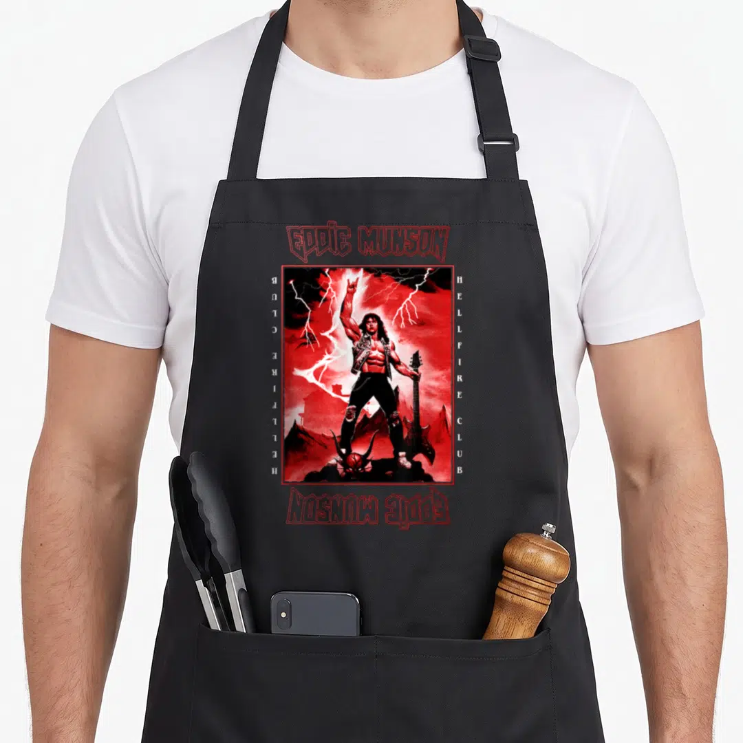 Eddie guitar apron - Red and black Eddie Munson Hellfire Club poster art with lightning and guitar — shown on a black cotton canvas apron against a white background