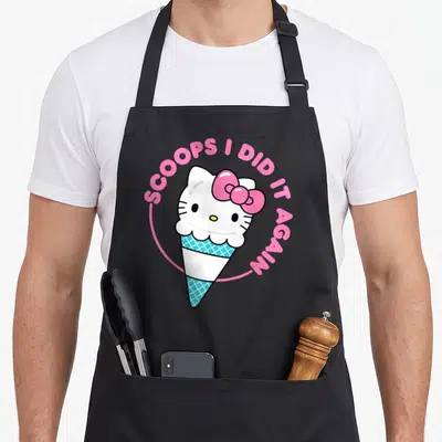 Cone scoop ice cream apron - Hello Kitty head merged with blue waffle cone and pink bow surrounded by arched text — shown on a black cotton canvas apron against a white background