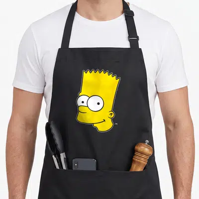 Bart face apron - Yellow cartoon head with spiky hair and wide eyes outlined in black — shown on a black cotton canvas apron against a white background