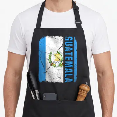Root guatemalan aprons - Distressed Guatemala flag print with vertical text and centered coat of arms on white band — shown on a black cotton canvas apron against a white background
