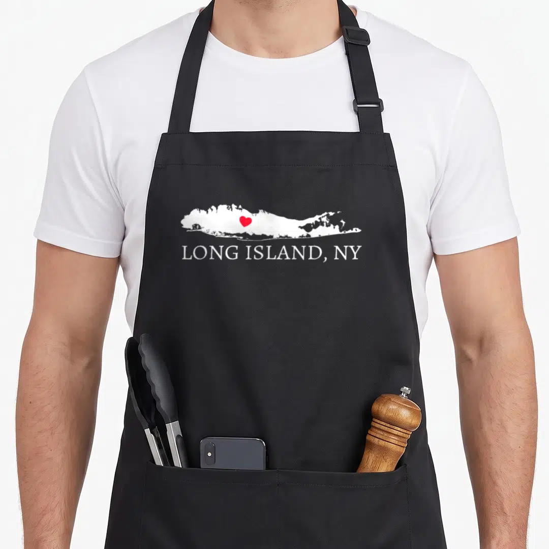 Funny souvenir kitchen island apron - White Long Island map outline with red heart and text LONG ISLAND, NY — shown on a black cotton canvas apron against a white background