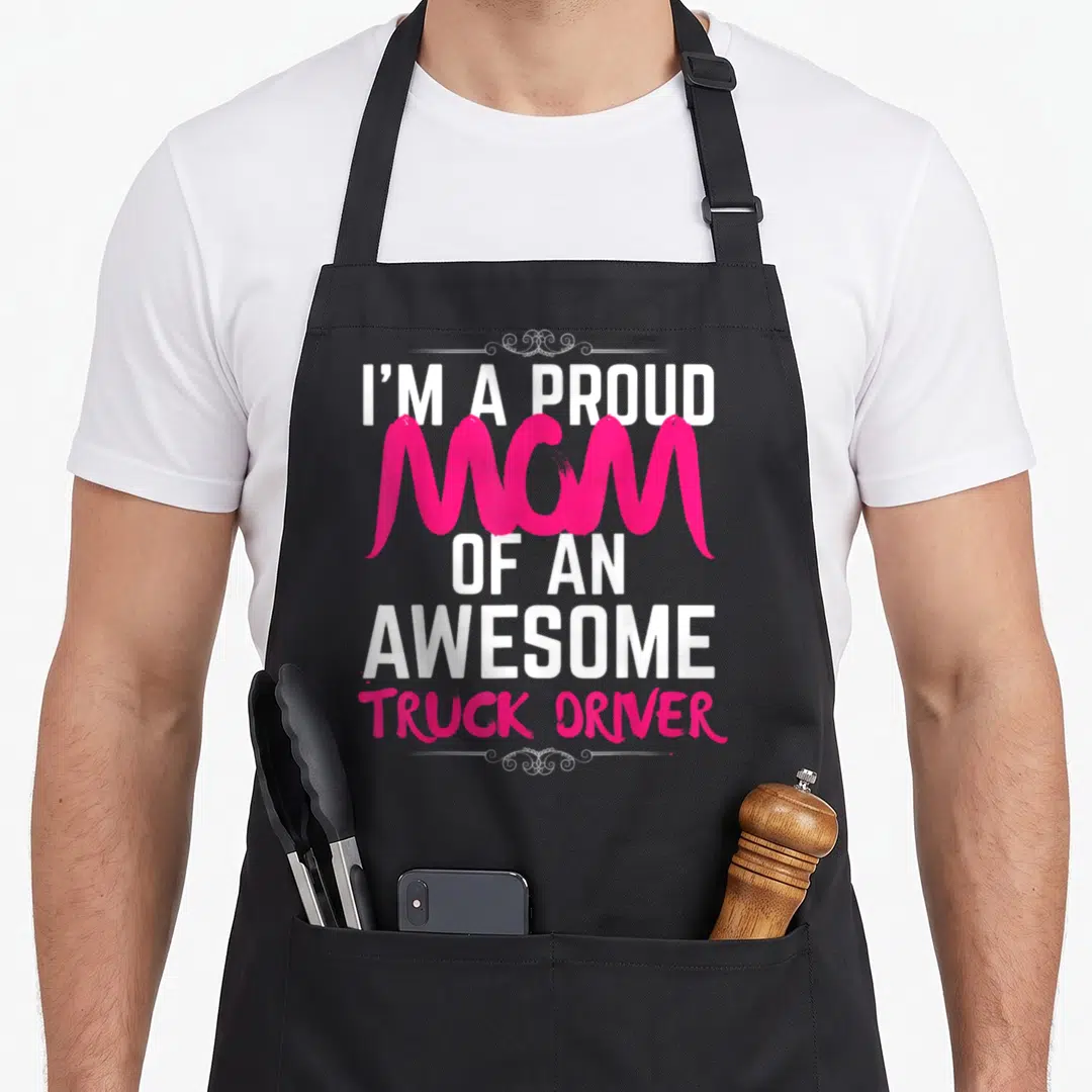 Driver proud truck apron - Pink and white stacked text reading I'M A PROUD MOM OF AN AWESOME TRUCK DRIVER — shown on a black cotton canvas apron against a white background