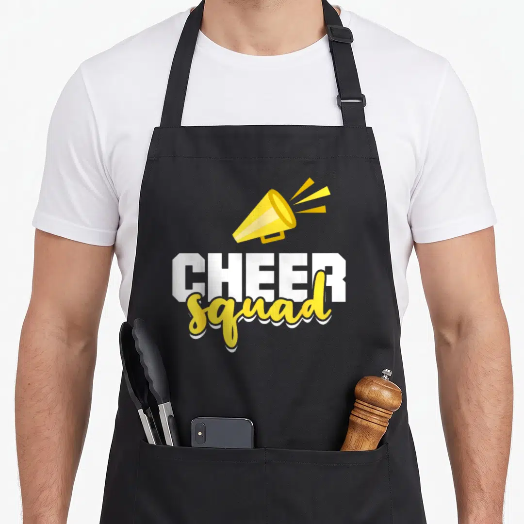 Squad cheer apron - Yellow megaphone above white CHEER and yellow squad text — shown on a black cotton canvas apron against a white background