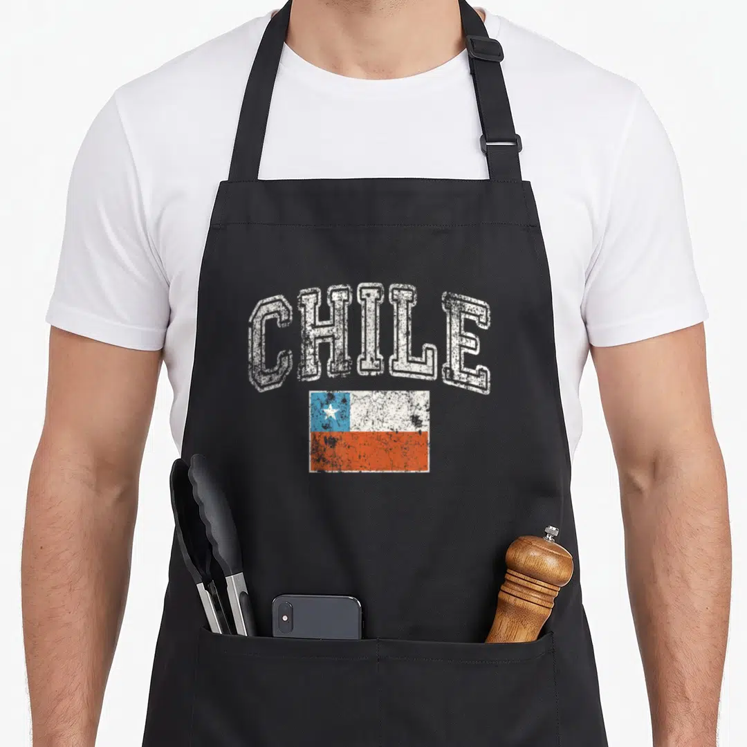 Faded chile pride apron - Arched CHILE text above a distressed white blue and red flag of Chile — shown on a black cotton canvas apron against a white background