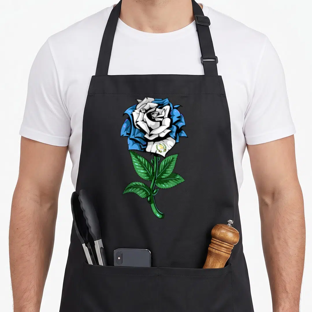 Flag guatemalan aprons - Blue and white rose with green stem and small emblem on a petal — shown on a black cotton canvas apron against a white background