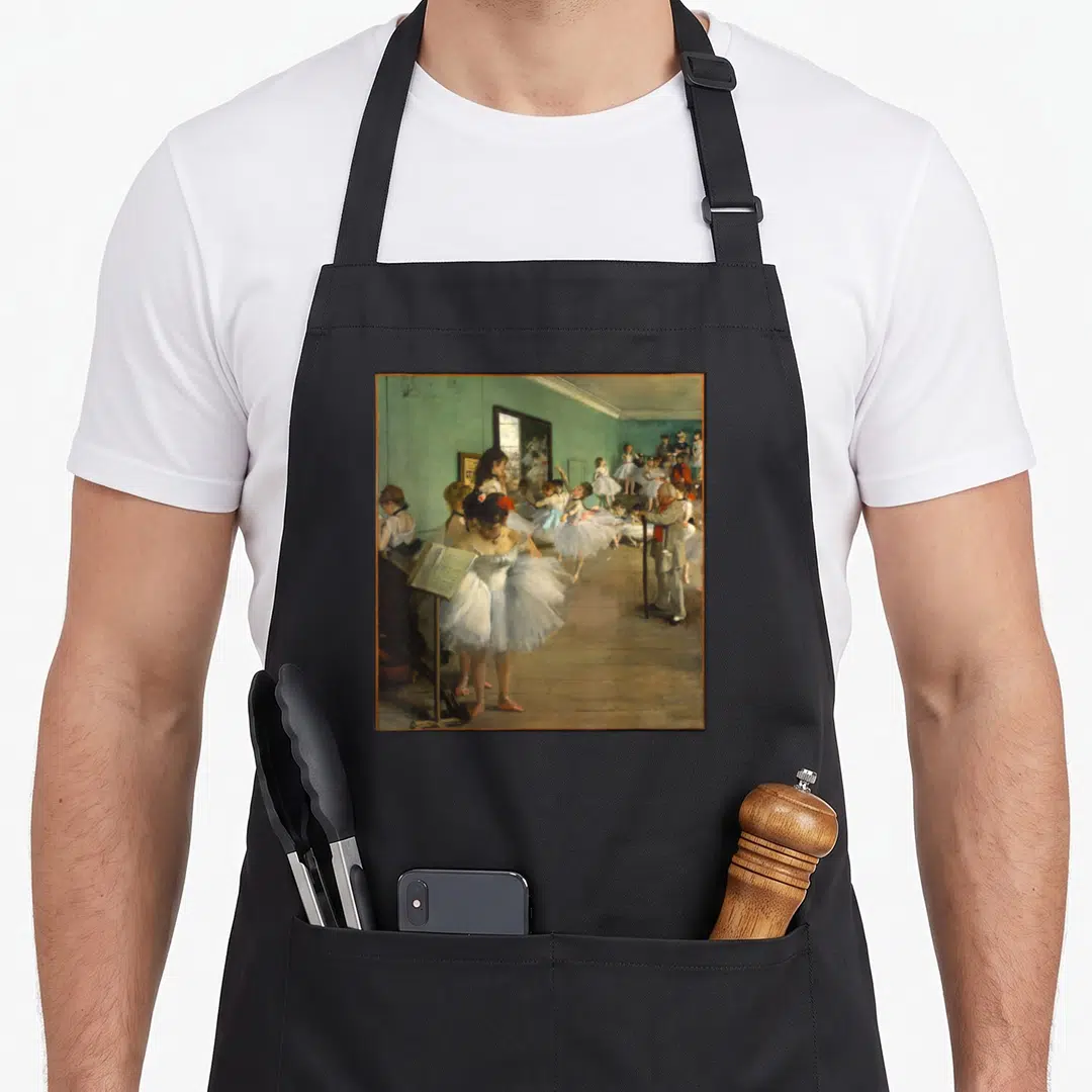 Edgar art class apron - Ballerinas in white tutus in a teal studio with an instructor standing by a mirror — shown on a black cotton canvas apron against a white background