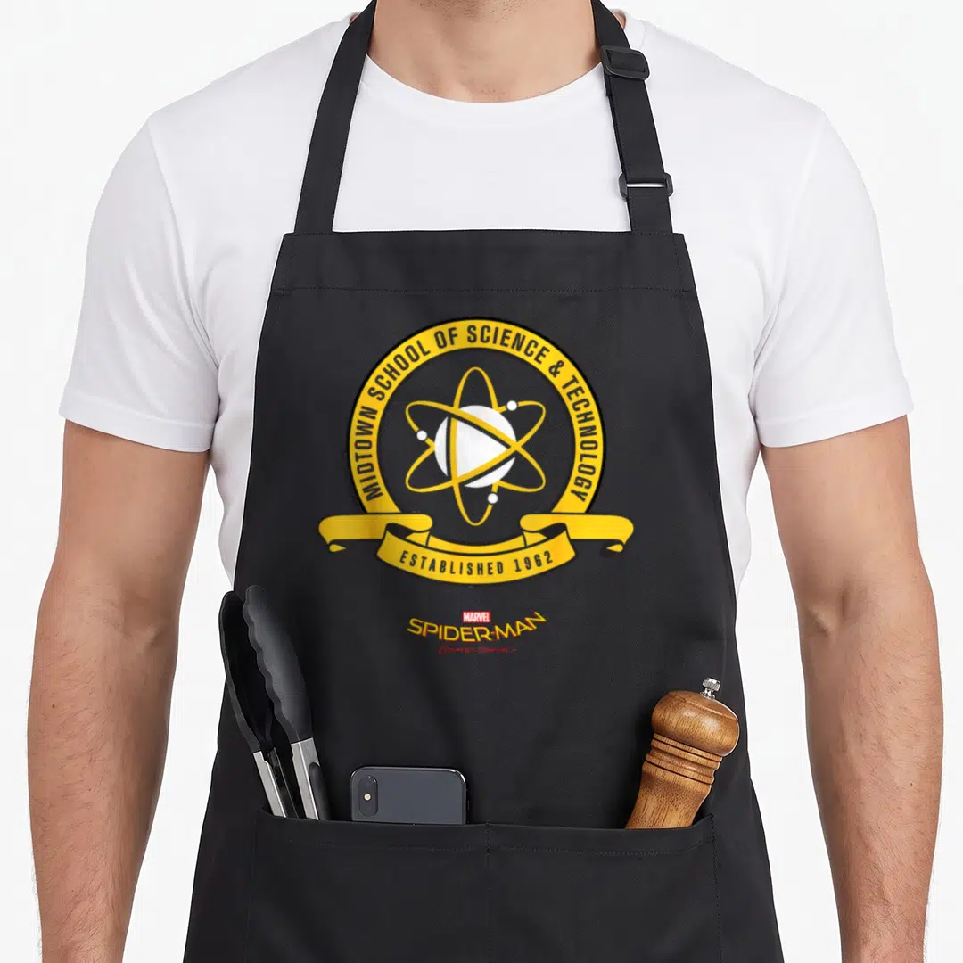 Homecoming uniform apron - Yellow school seal with atom symbol and Spider-Man Homecoming text in red — shown on a black cotton canvas apron against a white background