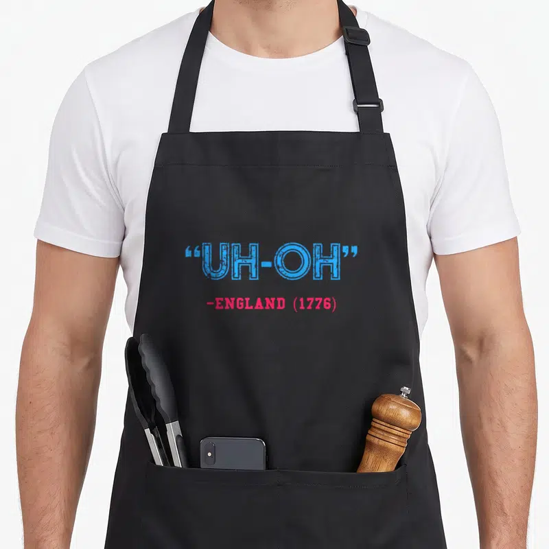 England 4th of july apron - Stacked blue UH-OH and red -ENGLAND (1776) distressed typography — shown on a black cotton canvas apron against a white background