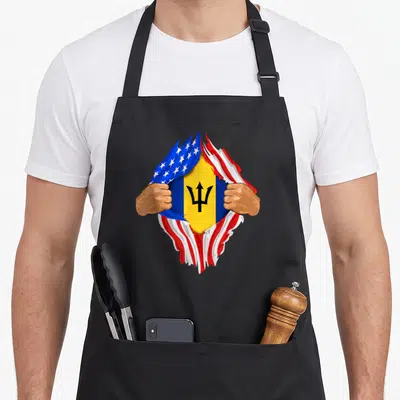 Barbadian blood apron - Two hands tearing USA flag to reveal Barbados flag with trident in blue red white yellow — shown on a black cotton canvas apron against a white background