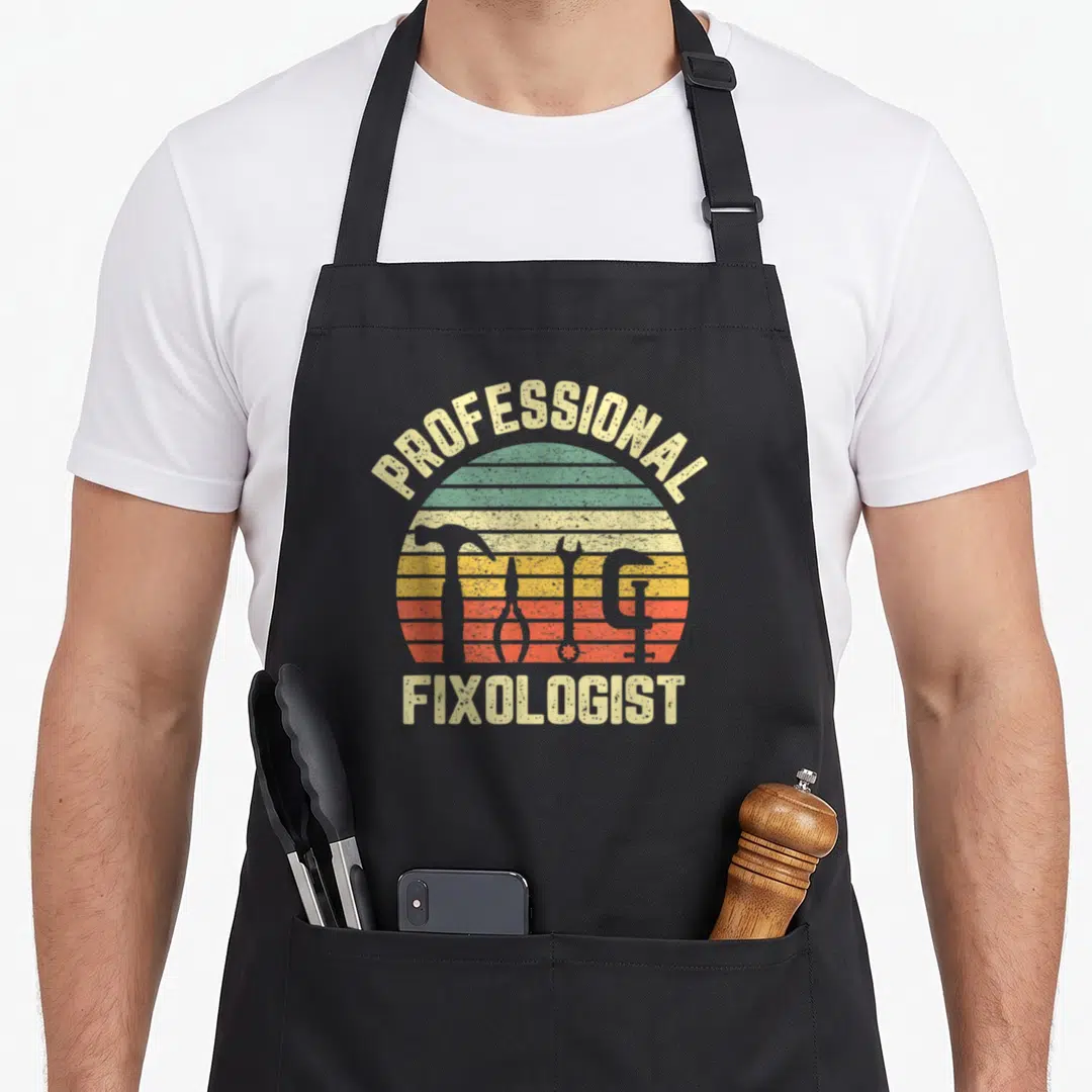 Professional handyman apron - Retro fixologist text with three tool silhouettes inside a striped sun in yellow green — shown on a black cotton canvas apron against a white background