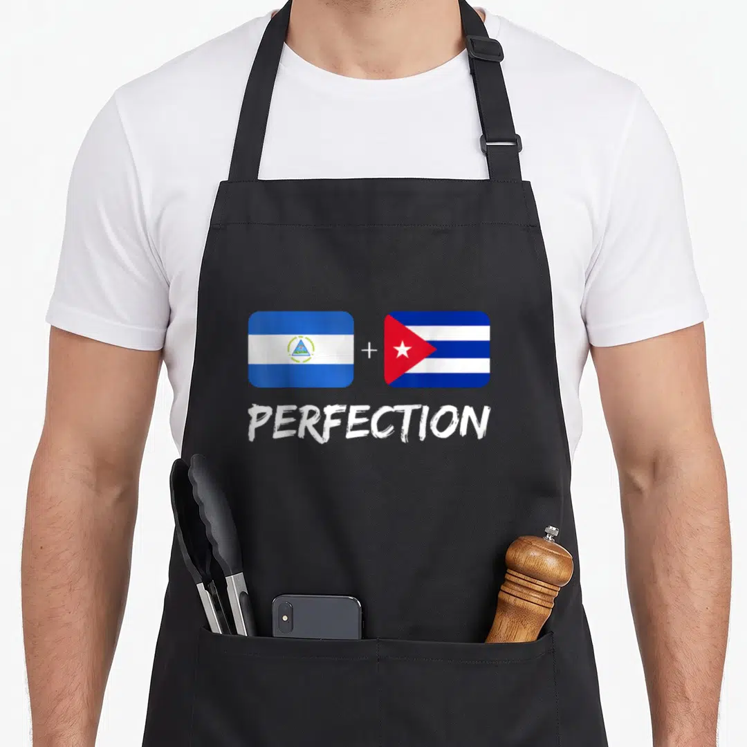 Cuban perfection heritage aprons - Two rectangular flags with plus sign and word PERFECTION in white — shown on a black cotton canvas apron against a white background