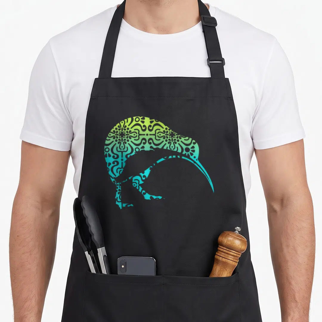 Tribal new zealand apron - Kiwi bird silhouette filled with blue green yellow gradient mandala pattern — shown on a black cotton canvas apron against a white background