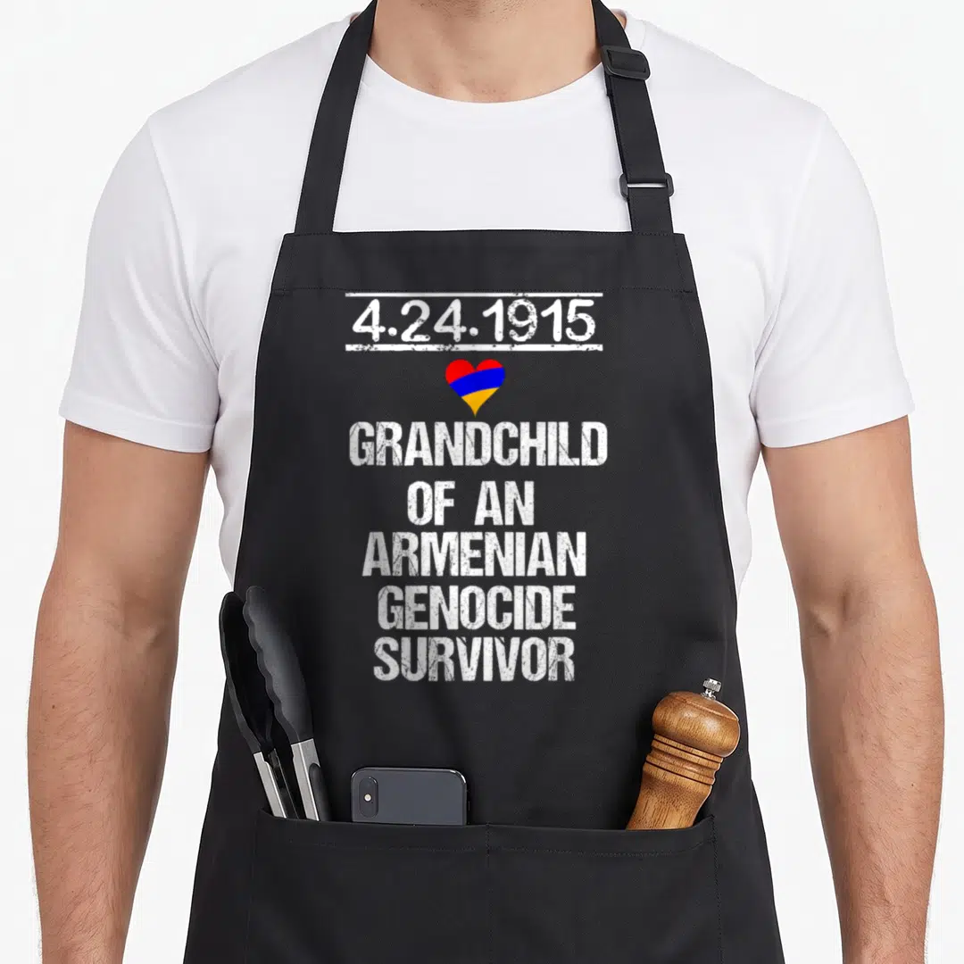 Genocide pride apron - Date 4.24.1915 above red blue and orange heart with stacked white distressed text — shown on a black cotton canvas apron against a white background