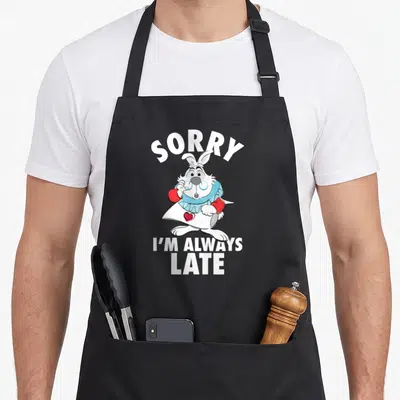 Alway alice wonderland apron - White Rabbit cartoon holding blue glasses with SORRY I'M ALWAYS LATE text — shown on a black cotton canvas apron against a white background