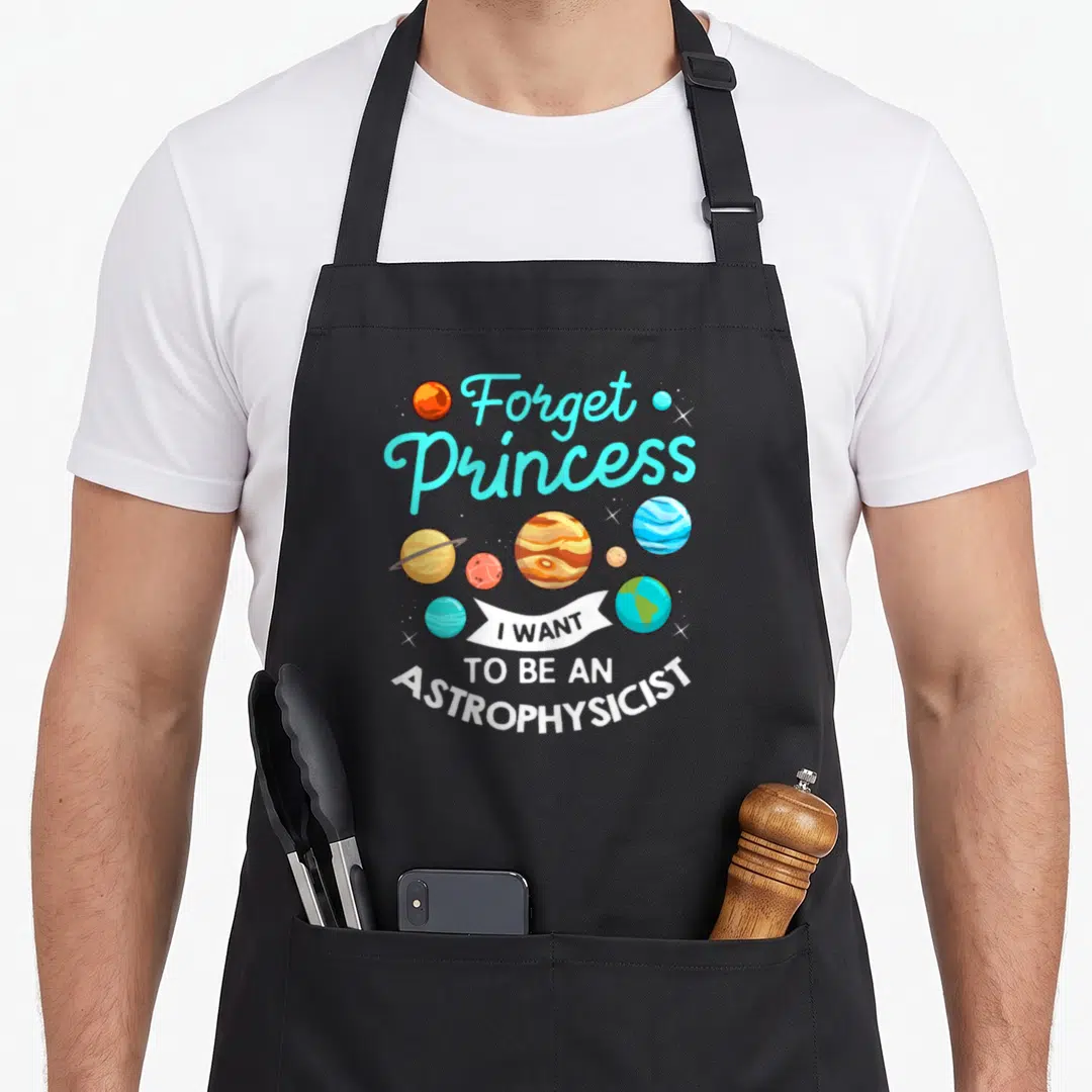 Forget astrophysicist princess apron - Cartoon planets in orange and blue with cyan text and white banner reading I — shown on a black cotton canvas apron against a white background