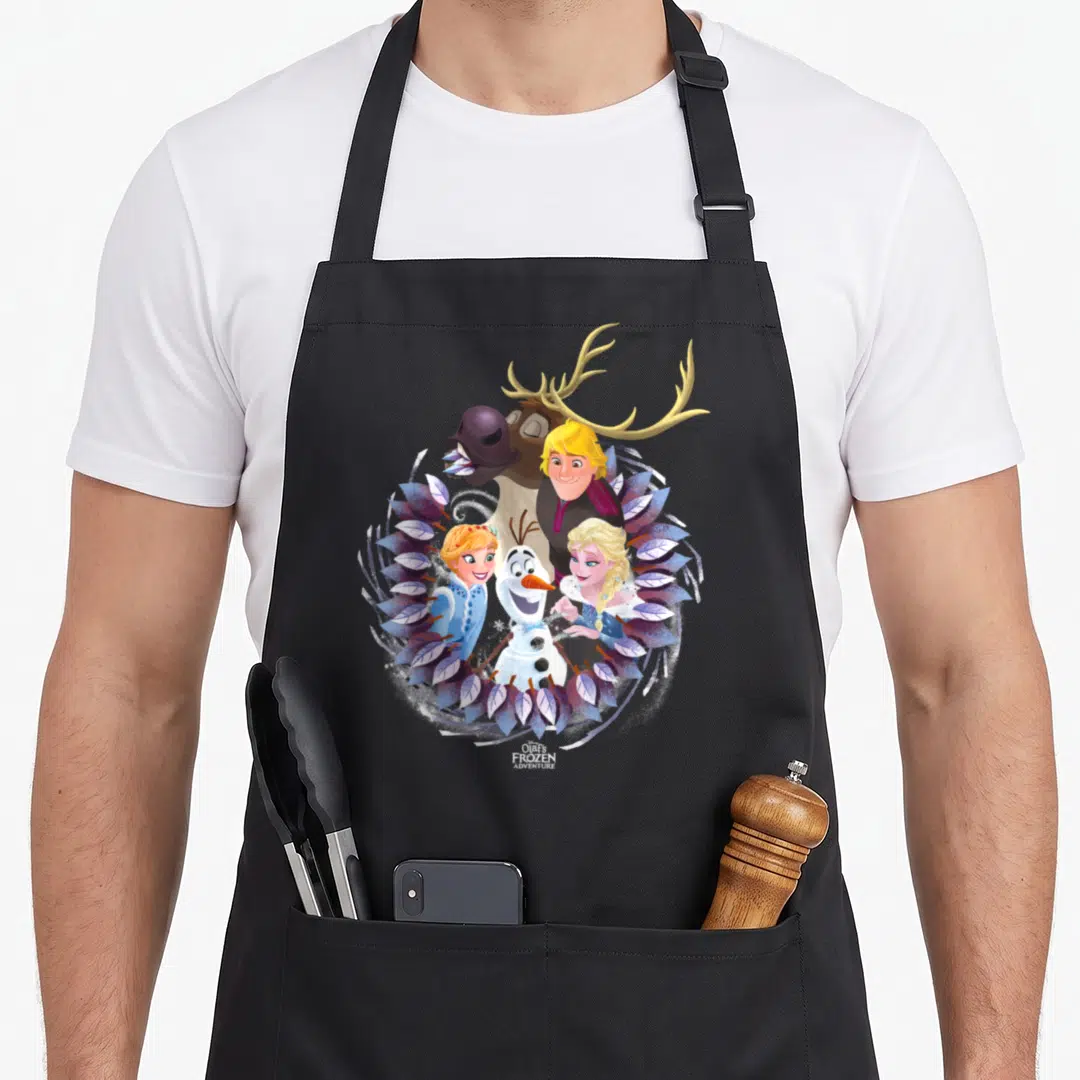 Frozen christmas apron - Olaf, Elsa, Anna, Kristoff, and Sven inside a purple and blue leaf wreath with white snowflakes — shown on a black cotton canvas apron against a white background