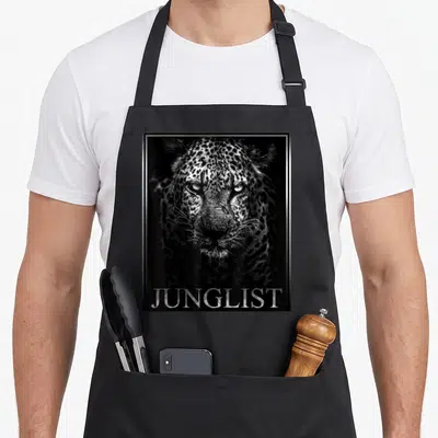 Drum dubstep apron - Black white silver leopard photo in silver frame with JUNGLIST text at bottom — shown on a black cotton canvas apron against a white background