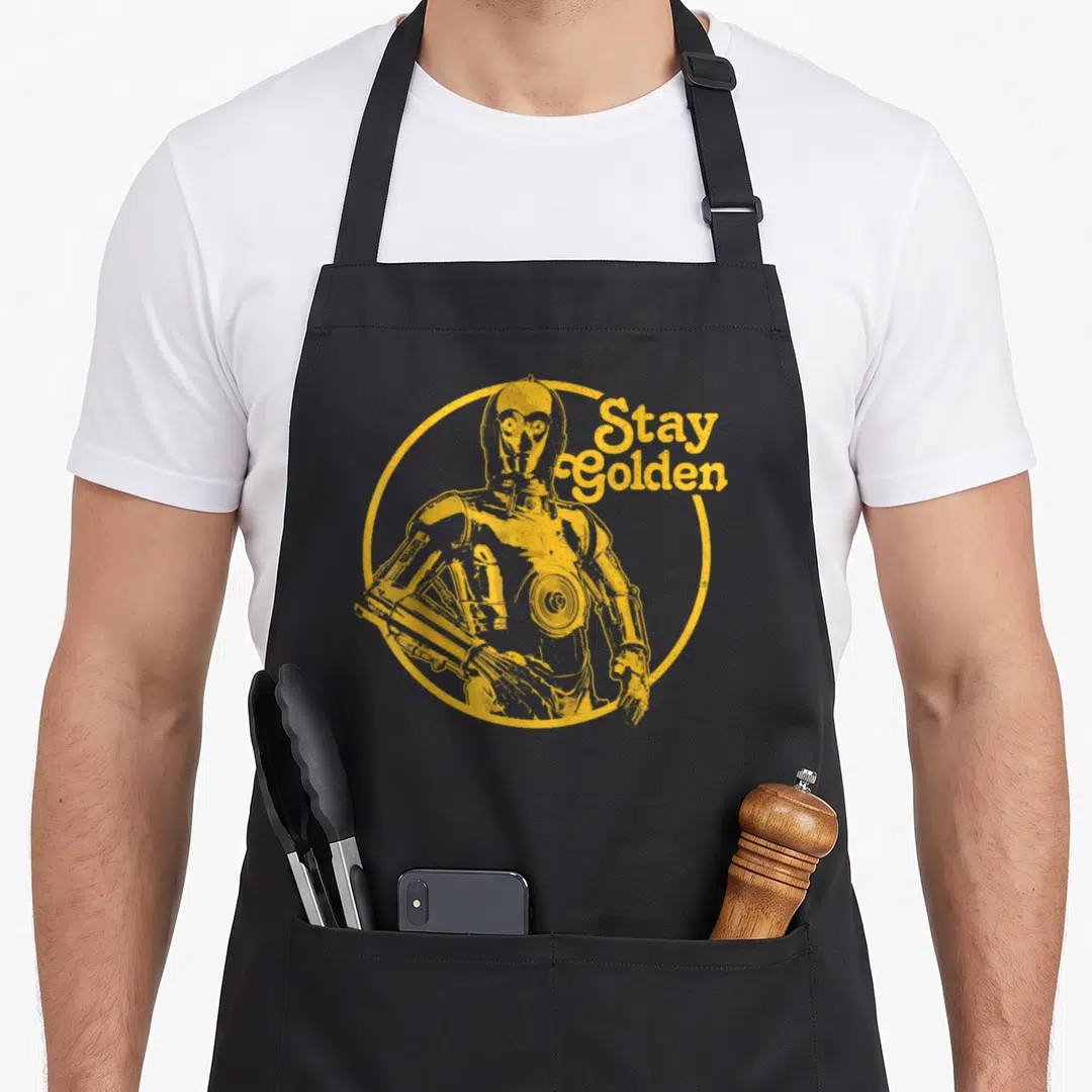 3po golden apron - Yellow distressed C-3PO inside circle with Stay Golden text — shown on a black cotton canvas apron against a white background