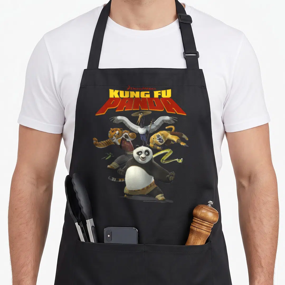 Panda kung apron - Stacked Kung Fu Panda logo above Po and five characters in dynamic poses — shown on a black cotton canvas apron against a white background
