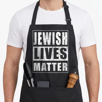 Patriot jewish apron - White stacked typography reading JEWISH LIVES MATTER inside a rectangular border — shown on a black cotton canvas apron against a white background