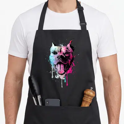 Bully puppy lover apron - Multicolored watercolor dog head with pink, blue, purple, and yellow splatters — shown on a black cotton canvas apron against a white background