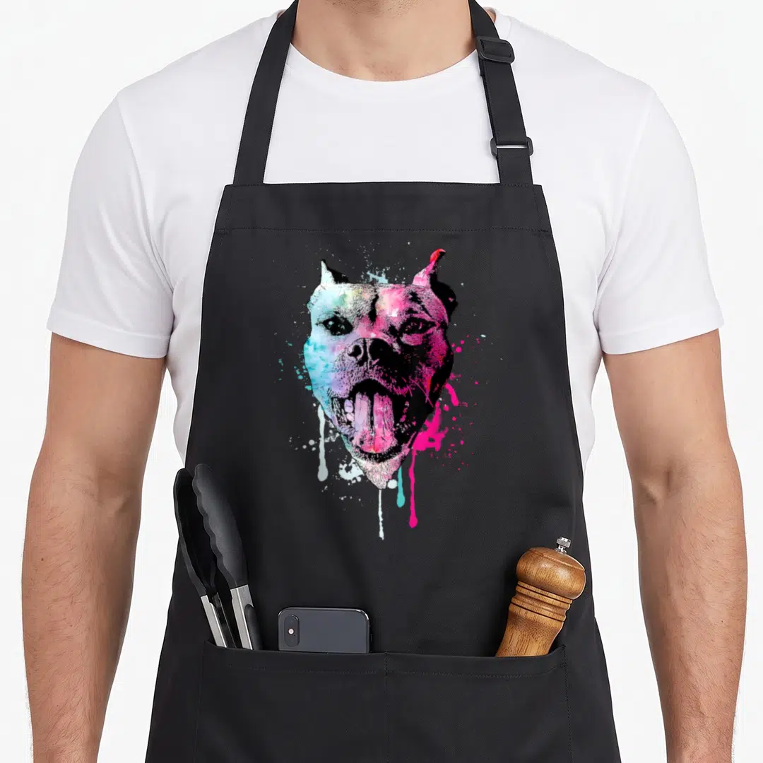 Bully puppy lover apron - Multicolored watercolor dog head with pink, blue, purple, and yellow splatters — shown on a black cotton canvas apron against a white background