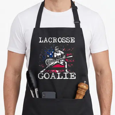 Lax goalie apron - Lacrosse goalie and distressed American flag print in white red and blue — shown on a black cotton canvas apron against a white background