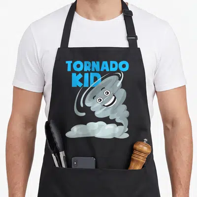 Hurricane hunter apron - TORNADO KID text next to a smiling grey cartoon tornado on a cloud base in blue and white art — shown on a black cotton canvas apron against a white background