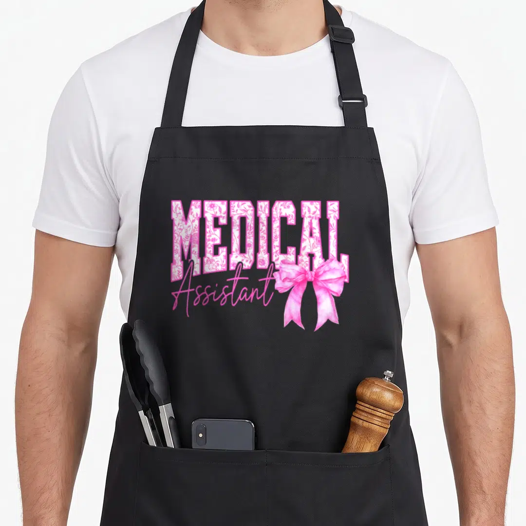 Medical mother's day aprons - MEDICAL floral text with pink script Assistant and large pink bow — shown on a black cotton canvas apron against a white background
