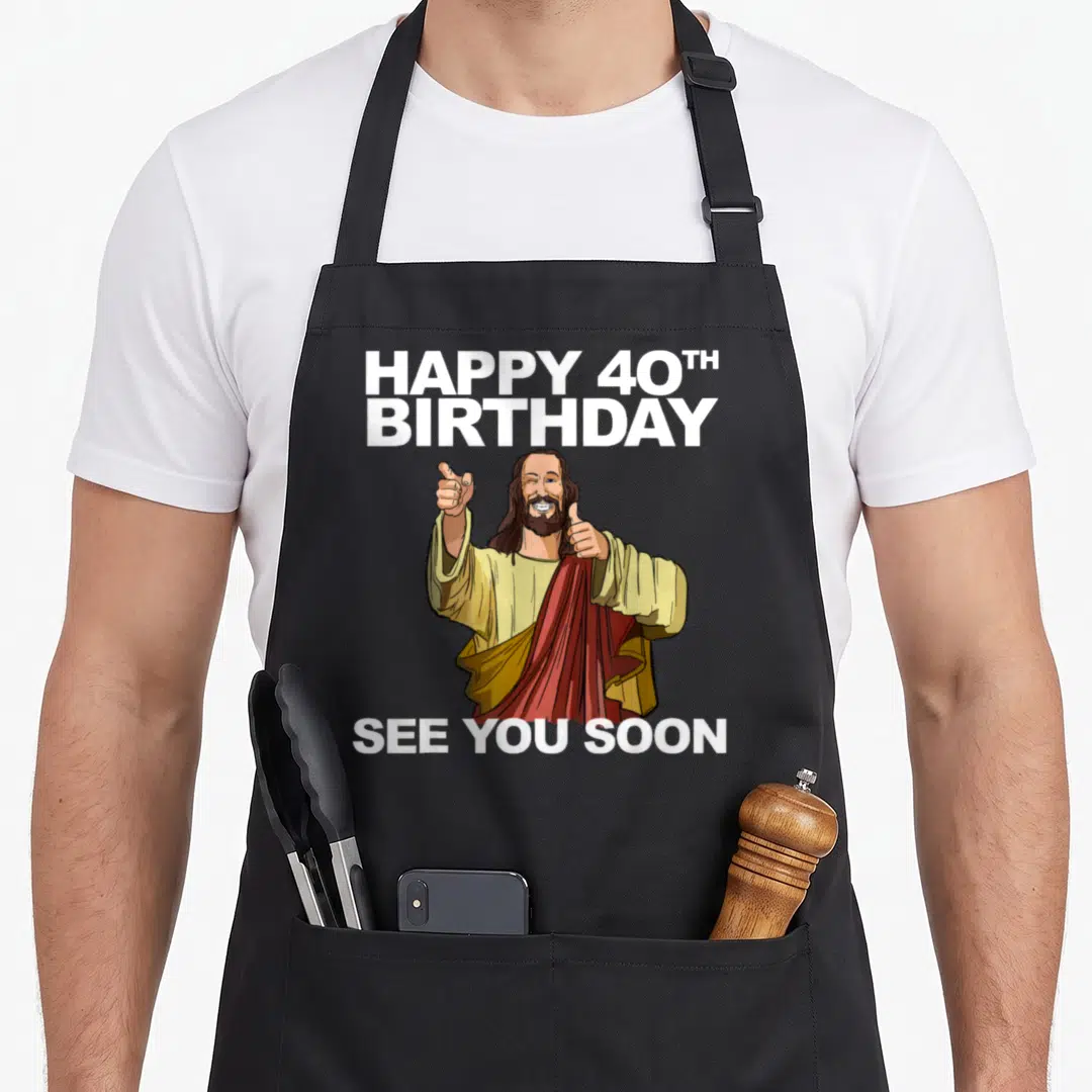 Jesus 40th apron - Cartoon figure giving two thumbs up surrounded by white text reading HAPPY 40TH BIRTHDAY and SEE YOU — shown on a black cotton canvas apron against a white background