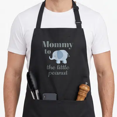 Baby couple apron - Light blue cartoon elephant with Mommy to the little peanut text — shown on a black cotton canvas apron against a white background